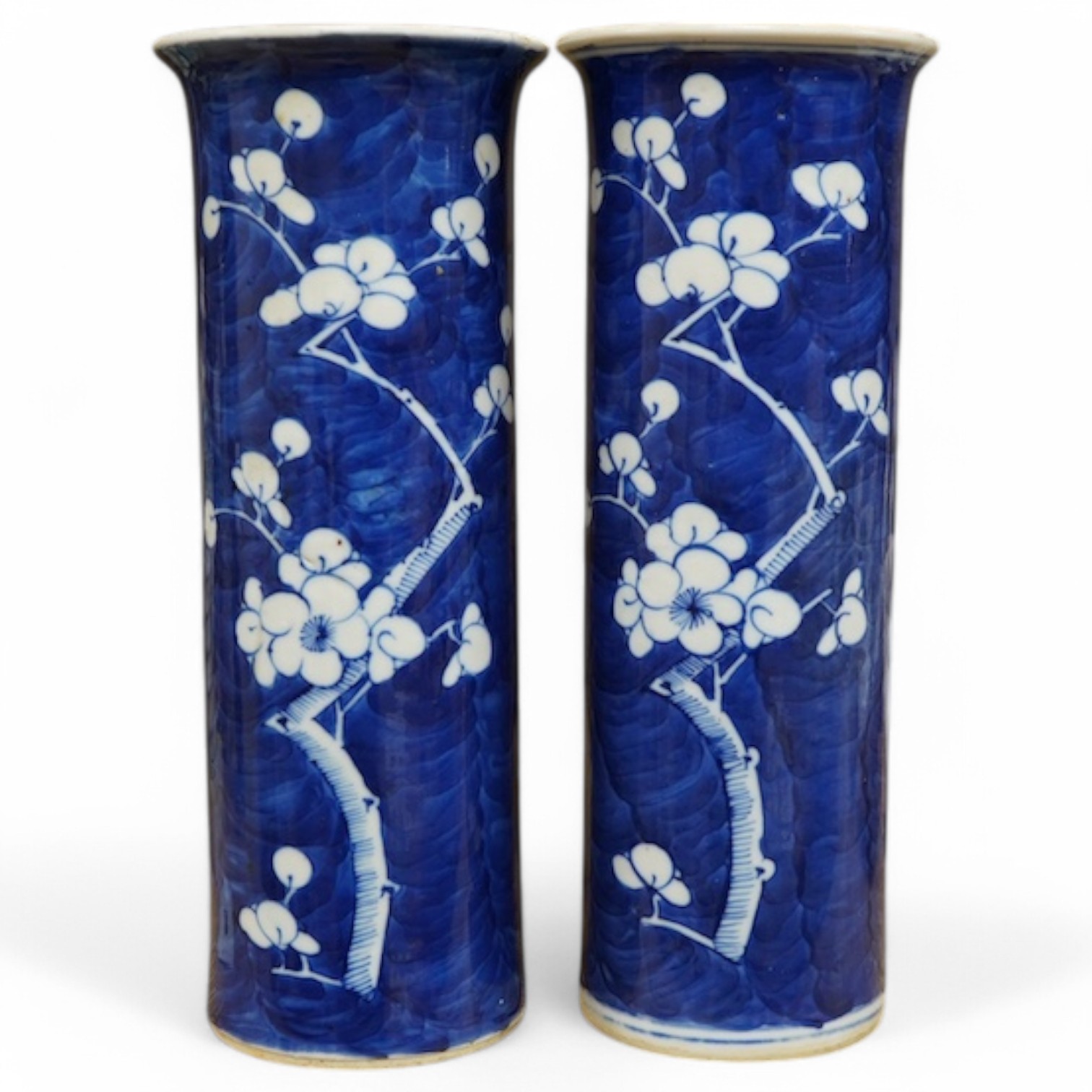 A pair of Chinese prunus flower sleeve vases, 21cm high. Condition - cracked